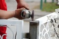 Worker use metal grinding wheel to grind the iron pole