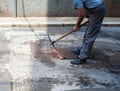 Worker use pickaxe fix cast iron manhole