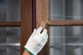 Worker use sandpaper removing the old surface of wooden window before apply wood preserver Royalty Free Stock Photo