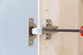 Polished Stainless door hinge on a cabinet door for interior design Royalty Free Stock Photo