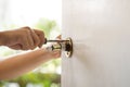 Worker use a screwdriver to remove and installing a Door knob, selective focus,Home Maintenance Concepts