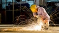 worker uses grinding cut metal, focus on flash light line of sharp spark,in low light Royalty Free Stock Photo