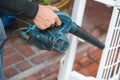 Worker uses a hand-held blower to remove dust