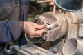 worker uses his hands to make the final polishing of stainless steel parts at a metal products manufacturing plant Royalty Free Stock Photo