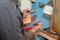 worker uses his hands to make the final polishing of stainless steel parts at a metal products manufacturing plant Royalty Free Stock Photo