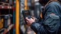 Worker uses a mobile data terminal for inventory in a busy warehouse