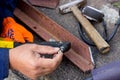 The worker uses a rivet hand gun, and inserts a rivet into it. Manual rivet wrench