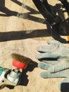 The worker uses a sander to clean the railing from paint