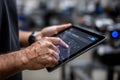 Worker uses tablet in a workshop setting for tasks Royalty Free Stock Photo