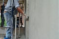 Worker uses the trowel for plastering the brickwork wall by mixed cement