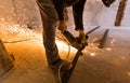 Worker is using angle grinder with fountain of sparks in apartment that is under construction, remodeling, renovation Royalty Free Stock Photo