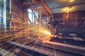 Worker is using angle grinder with fountain of sparks in apartment that is under construction, remodeling, renovation Royalty Free Stock Photo