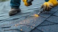 A worker using a blowtorch to melt and secure seams between different sections of roofing material Royalty Free Stock Photo