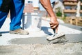 Construction worker using brush and primer for waterproofing house using hydroinsulation materials Royalty Free Stock Photo