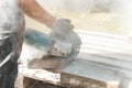 Worker using circular saw for cutting concrete block for road Royalty Free Stock Photo