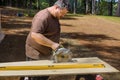 Worker using a circular saw to cut plywood using a circular saw held in his hand Royalty Free Stock Photo