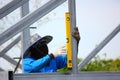 Worker using construction bubble level checking the steel structure in construction site Royalty Free Stock Photo