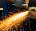 Worker using electric grinder