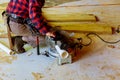 Worker using electric saw cutting pvc pipe in construction new commercial construction Royalty Free Stock Photo