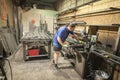 Worker using electric wheel grinding on steel structure in factory Royalty Free Stock Photo