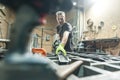 Worker using electric wheel grinding on steel structure in factory Royalty Free Stock Photo