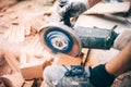 Worker using grinder on construction site for cutting bricks, debris. Tools and bricks on new building site Royalty Free Stock Photo