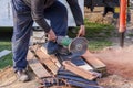 Worker using a hand circular saw to cut roof-tile Royalty Free Stock Photo