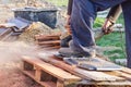 Worker using a hand circular saw to cut roof-tile Royalty Free Stock Photo