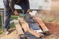 Worker using a hand circular saw to cut a roof-tile Royalty Free Stock Photo