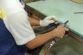 Worker using handy air belt sander