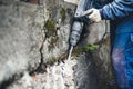 Worker using a jackhammer to drill into wall. professional worker in construction site Royalty Free Stock Photo