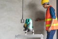 Worker using laser level machine in the renovation room Royalty Free Stock Photo