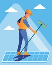 A worker using a longhandled squeegee to deftly remove leaves and other debris from solar panels on a rooftop.. Vector Royalty Free Stock Photo