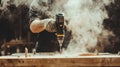 Worker using power drill on wooden surface, creating sawdust and smoke Royalty Free Stock Photo