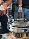 Worker using power impact on transmission planetary gear assembly Royalty Free Stock Photo