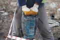 Worker using a power tool in a construction site at daytime Royalty Free Stock Photo