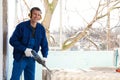 Worker using rotary drill hammer for window installation