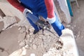 Worker using rotary drill hammer for window installation indoors