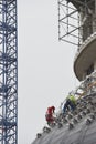 Worker using safety strap on the roof of a bulding under constru