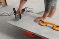 Worker using saw with circular diamond blade for tile cutting indoors, closeup