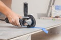 Worker using saw with circular diamond blade for tile cutting indoors, closeup