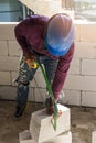 Worker using saw for cutting foam bricks Royalty Free Stock Photo