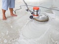 Worker using scrubber machine for cleaning and polishing floor Royalty Free Stock Photo