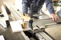 Worker using silicone glueCloseup process of carpenter worker with circular saw machine at wood beam cross cutting during Royalty Free Stock Photo