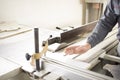 Worker using silicone glueCloseup process of carpenter worker with circular saw machine at wood beam cross cutting during Royalty Free Stock Photo