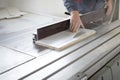 Worker using silicone glueCloseup process of carpenter worker with circular saw machine at wood beam cross cutting during Royalty Free Stock Photo