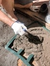 Worker hands using spatula, plastic form and plastering ceiling with putty. Mesh on split. Closeup Royalty Free Stock Photo