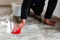 Worker using a sponge rub washing tiles after jointing.