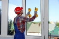 Worker using suction lifters during plastic window installation indoors Royalty Free Stock Photo