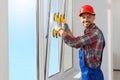 Worker using suction lifters during plastic window installation indoors Royalty Free Stock Photo